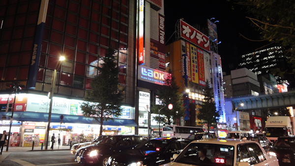large buildings with logos and vertical japanese text